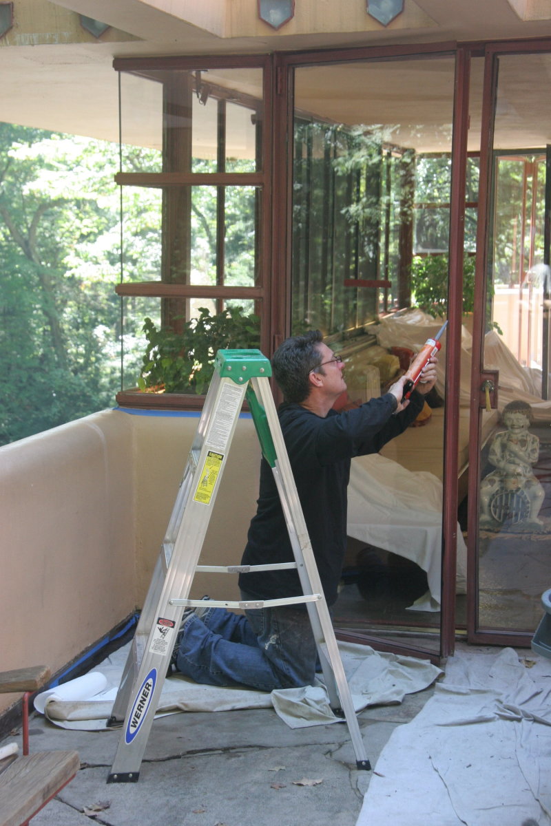 A Seekircher team member refurbishing one of the steel French doors at Frank Lloyd Wright's Fallingwater.