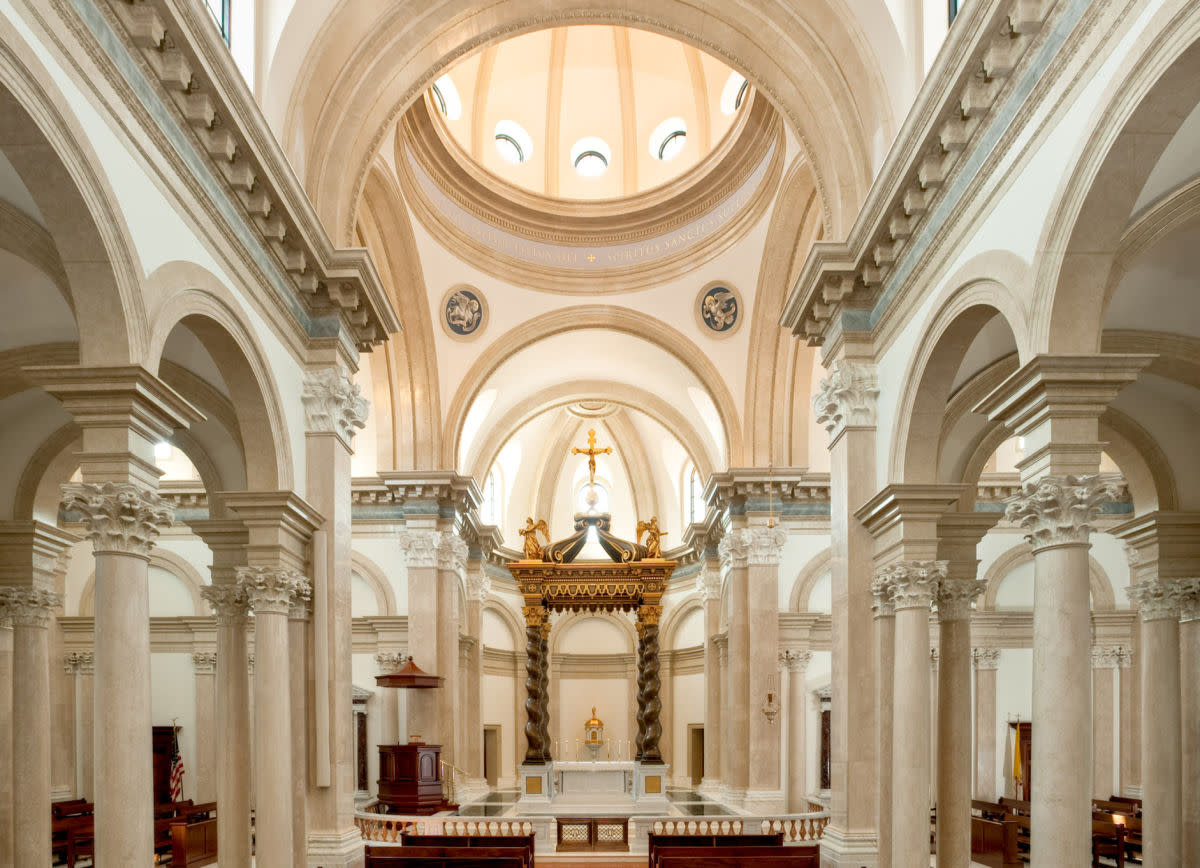 The Nave Interior - The cruciform chapel culminates at the sanctuary and dome, which reaches seventy-two feet from the floor. The four Evangelists are depicted in pendentives of the dome, while the twelve tondi windows represent the twelve Apostles.